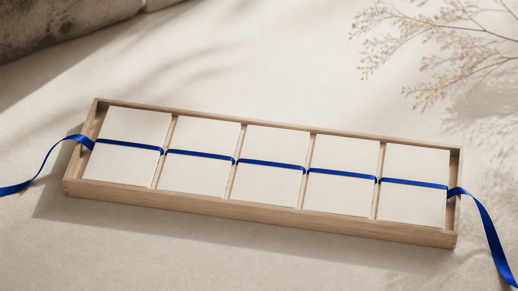 Editorial image of a curated collection held together by a cobalt ribbon.